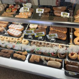 a variety of doughnuts in a display case