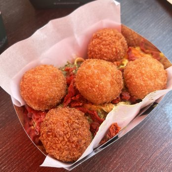 PastaSole - Fried Arancini over Pesto and Dried Tomato Pasta - Italian Near Me - New York, New York PastaSole - Fried Arancini over Pesto and Dried Tomato Pasta - Italian Near Me - New York, New York