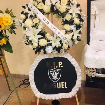 Robinson's Flowers - Large black, white, and silver wreath...Raider colors. - Florists Near Me - La Puente, California