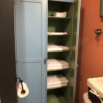 Juniper Lane Guest House - Antique small painted armoire used to hold towels, a hair dryer, white and colorful terry cloth towels in Cedar/ Mandala bathroom - Hotels Near Me - Friday Harbor, Washington Juniper Lane Guest House - Antique small painted armoire used to hold towels, a hair dryer, white and colorful terry cloth towels in Cedar/ Mandala bathroom - Hotels Near Me - Friday Harbor, Washington