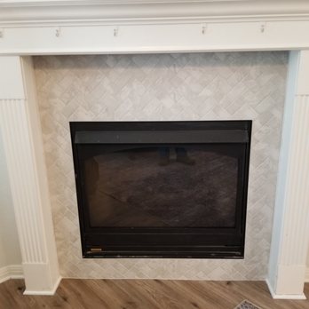The Tile Guy - Our new tile around the fireplace and you can see our new flooring too.  So happy how it turned out. - Building Supplies Near Me - Austin, Texas