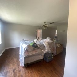 Coronas Painting & More - Material was on floors to avoid paint spills and plastic on couches to protect them as well.