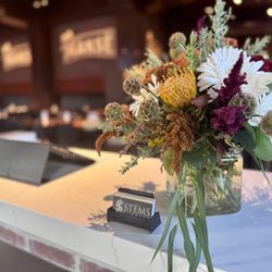 Stems Florist - Beautiful floral display by Stems Floral at Mäksē Restaurant, adding a warm welcome for our guests