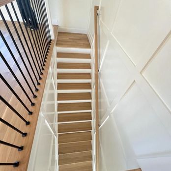 Axel General Construction - a man standing at the top of a staircase - General Contractors Near Me