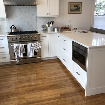 RK Construction Company - a kitchen with white cabinets and wood floors - General Contractors Near Me - Norwood, Massachusetts RK Construction Company - a kitchen with white cabinets and wood floors - General Contractors Near Me - Norwood, Massachusetts