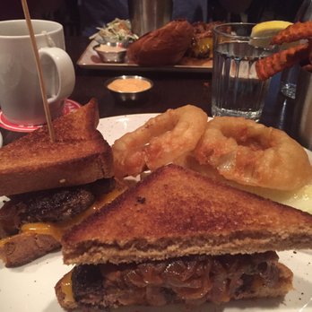 Red Cow St. Paul - Patty melt with onion rings and sweet potato fries. In the background, the Cowboy burger w/ pulled pork. - Burgers Near Me - St Paul, Minnesota Red Cow St. Paul - Patty melt with onion rings and sweet potato fries. In the background, the Cowboy burger w/ pulled pork. - Burgers Near Me - St Paul, Minnesota