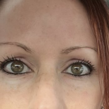 Chicago Microblading - Before - A close-up image of a woman's face focusing on her eyes and forehead, taken inside a car. - Permanent Makeup Near Me - Schaumburg, Illinois