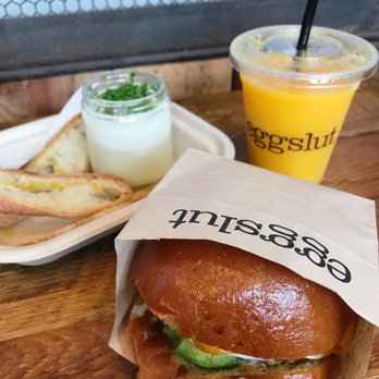Eggslut - Sausage, egg, and cheese with avocado sandwich. The Slut. OJ. - Breakfast & Brunch Near Me - Los Angeles, California