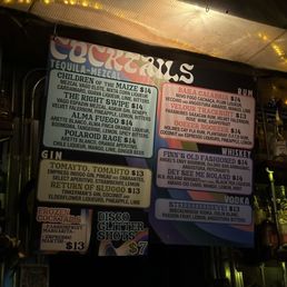 Bar menu - A colorful menu board at Finn's Manor in Denver lists various cocktails, spirits, and drinks, including tequila, rum, whiskey, gin, vodka, and frozen cocktails.