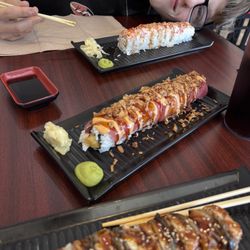 Glory Sushi - Black dragon roll in the poor ground, crunchy dynamite roll in the middle, and sweet and spicy roll in the back