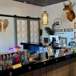 Interior wall featuring our logo, curated artwork, and themed décor inside the lobby.