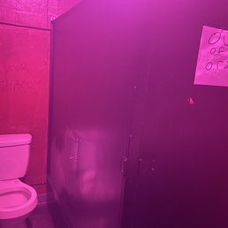Bathroom stall with a broken door and a broken toilet, another stall OOO completely. What????? Bathroom stall with a broken door and a broken toilet, another stall OOO completely. What?????