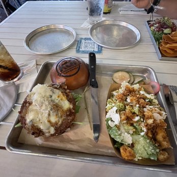 Kai Eats + Drinks - Plant based burger with ceasar salad as a side, shared plate poke in the background - Tacos Near Me - Kailua-Kona, Hawaii Kai Eats + Drinks - Plant based burger with ceasar salad as a side, shared plate poke in the background - Tacos Near Me - Kailua-Kona, Hawaii