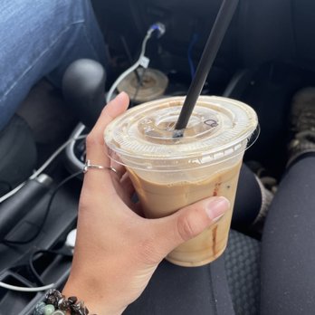 The Coffee Shop - a hand holding a cup of iced coffee - Coffee & Tea Near Me - McCleary, Washington The Coffee Shop - a hand holding a cup of iced coffee - Coffee & Tea Near Me - McCleary, Washington