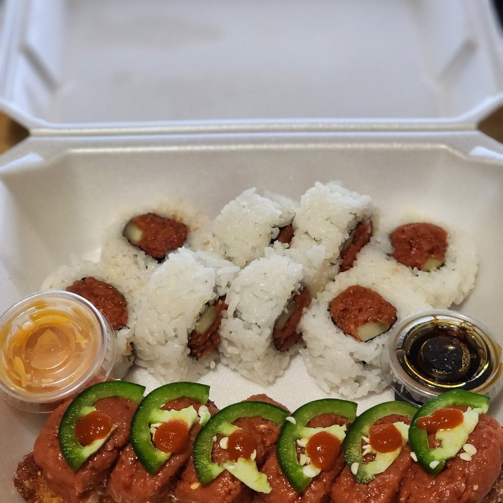 a tray of sushi and vegetables a tray of sushi and vegetables