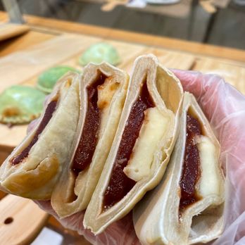 Marquin - a person holding a sandwich in their hand - Specialty Food Near Me - Toronto, Ontario Marquin - a person holding a sandwich in their hand - Specialty Food Near Me - Toronto, Ontario