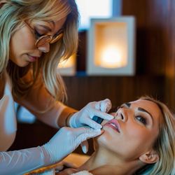Express Med Spa - Shorewood - A specialist at Express Med Spa performs a lip enhancement procedure on a relaxed client in a serene spa environment