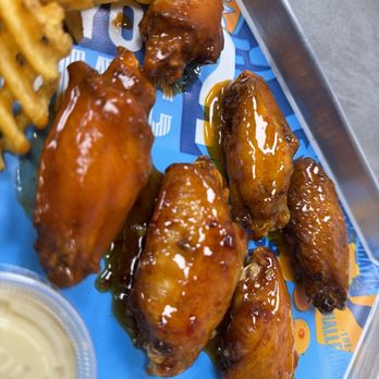 Atomic Wings - a tray of chicken wings and french fries - Chicken Wings Near Me - Houston, Texas