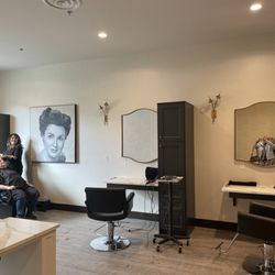 Salon Doré - Michelle rinsing out a customer's hair and two hair stations. Nail desk off to the left.