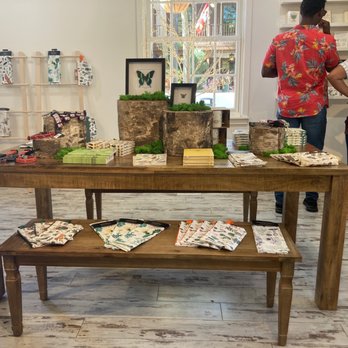 Hive & Homestead by Stubbees - two people standing in front of a table with various items on it - Home Decor Near Me - St. Augustine, Florida Hive & Homestead by Stubbees - two people standing in front of a table with various items on it - Home Decor Near Me - St. Augustine, Florida
