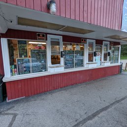 the outside of a store with a red building the outside of a store with a red building