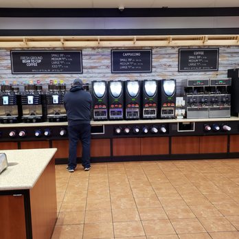 Oncue - a man standing in a coffee shop - Convenience Stores Near Me - Oklahoma City, Oklahoma