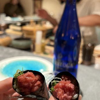 Sekai Omakase - a person holding a piece of sushi - Sushi Bars Near Me - New York, New York Sekai Omakase - a person holding a piece of sushi - Sushi Bars Near Me - New York, New York