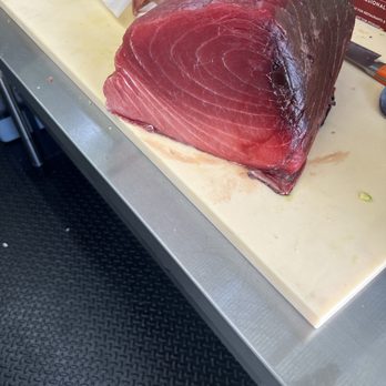 Masada Kosher Sushi And Catering - a piece of meat on a cutting board - Food Trucks Near Me