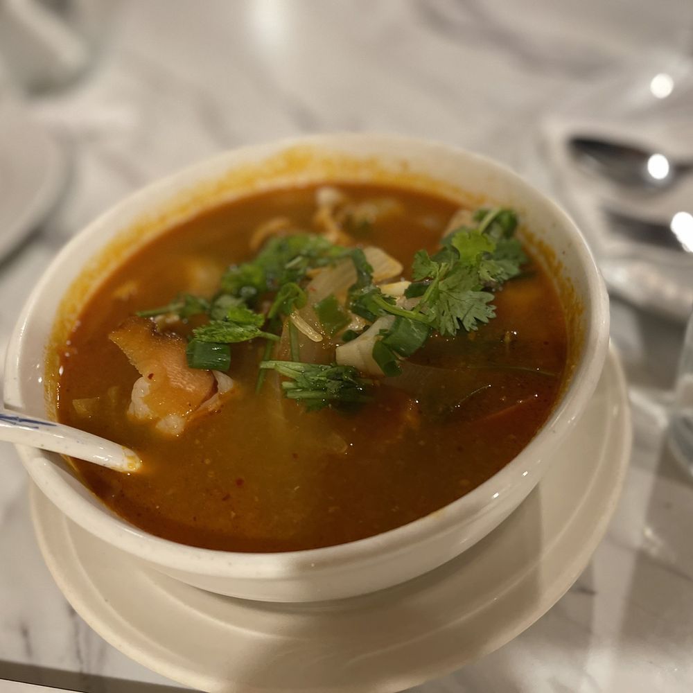 Siam Square - a bowl of soup with a spoon in it - Thai Near Me - Honolulu, Hawaii Siam Square - a bowl of soup with a spoon in it - Thai Near Me - Honolulu, Hawaii