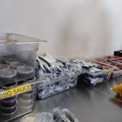 The Pit Sandwich Spot - Counter with self serve condiments, utensils and napkins.