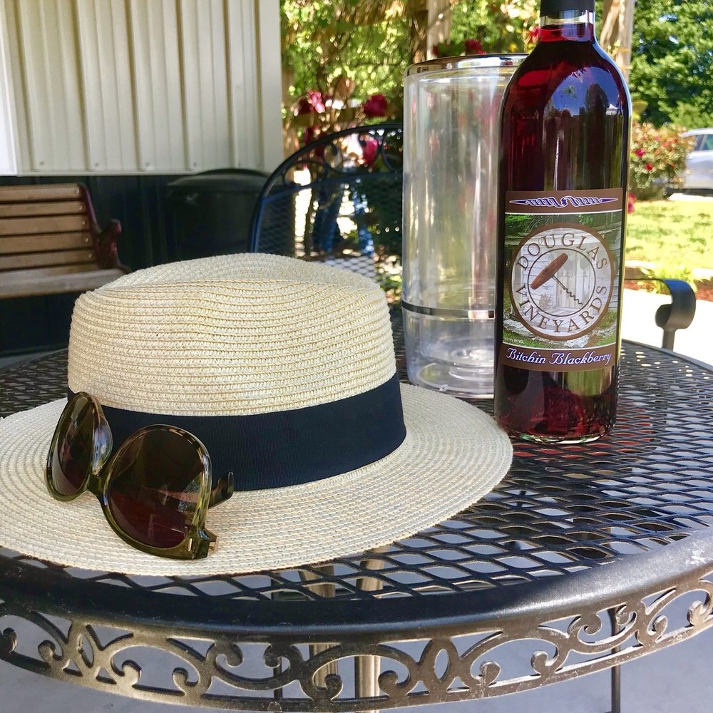 Douglas Vineyards - Outside table and a bottle of Bitchin Blackberry - Wine Tasting Room Near Me - Kannapolis, North Carolina