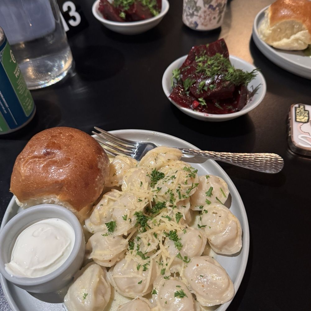 Classic pelmenis with parm and herb sauce and pickled beets on the side Classic pelmenis with parm and herb sauce and pickled beets on the side