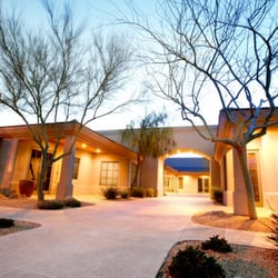 Exterior of our office entry with early evening lighting.