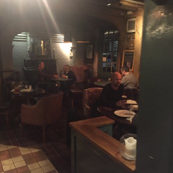 Ostrich Inn - Cosy seating area by fireplace.. - Pubs Near Me - Slough, SLG Ostrich Inn - Cosy seating area by fireplace.. - Pubs Near Me - Slough, SLG