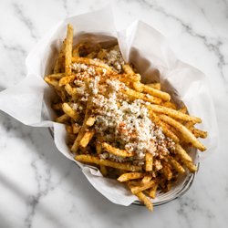 French fries blended with garlic sauce, feta cheese, herbs, and spices.