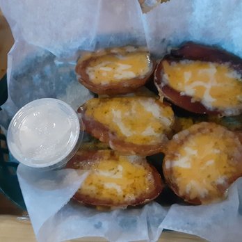 Russell Station Bar & Grill - Potato skins, sans the bacon. A delicious combination of Jack and cheddar cheeses. Served with sour cream. A must-do! - Bars Near Me - Rochester, New York Russell Station Bar & Grill - Potato skins, sans the bacon. A delicious combination of Jack and cheddar cheeses. Served with sour cream. A must-do! - Bars Near Me - Rochester, New York