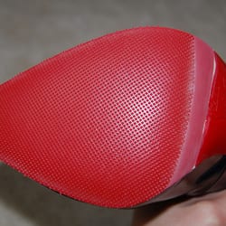 Roswell Wieuca Shoe Repair - The rubber sole was put on ok, but notice the color is a little off, and it kind of cut into the logo.