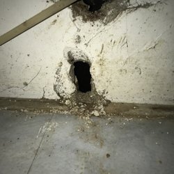 Holes in the drywall made by the plumber.