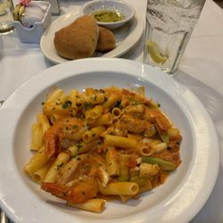 Capuano Flemington - Front: Jumbo shrimp, lump crab meat and asparagus over gluten free penne in cognac tomato cream sauce.  Back: Heart shaped bread.