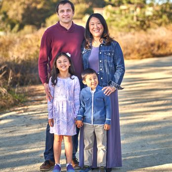 David Schneider Photography - Family standing together at sunset with golden sky - Session Photography Near Me