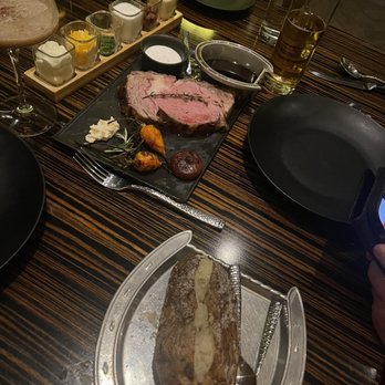 Jack Binion's Steak - Queen cut prime rib (med rare) w baked potato w toppings flight on the side. - Steakhouses Near Me - Las Vegas, Nevada Jack Binion's Steak - Queen cut prime rib (med rare) w baked potato w toppings flight on the side. - Steakhouses Near Me - Las Vegas, Nevada