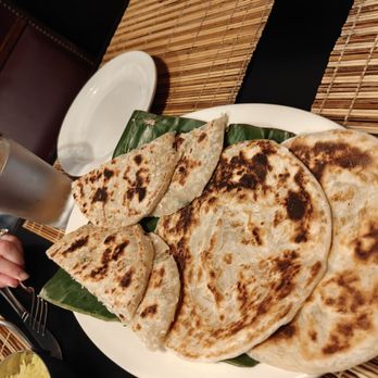 Cinnamon Grill - Paratha roti and coconut roti on a banana leaf. - Asian Fusion Near Me - New London, Connecticut Cinnamon Grill - Paratha roti and coconut roti on a banana leaf. - Asian Fusion Near Me - New London, Connecticut