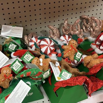 Walgreens - A collection of holiday decorations such as gingerbread ornaments, plush reindeer, peppermint candies, and red ribbons displayed on a store shelf. - Drugstores Near Me - Laurel, Maryland