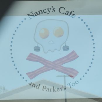 Nancy's Cafe - Sign in the window announcing. Nancy's Cafe and Parker's too, with a skull and crossbones depiction of Nancy made of eggs and bacon. - Breakfast & Brunch Near Me - Auburn, California