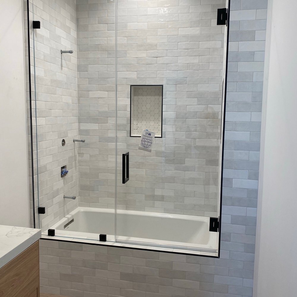 J's Custom Glass - Frameless ultra clear glass shower/tub combo door with matte black hardware - Windows Installation Near Me J's Custom Glass - Frameless ultra clear glass shower/tub combo door with matte black hardware - Windows Installation Near Me