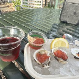 Fresh oysters in half shell and cold red wine. This is heaven