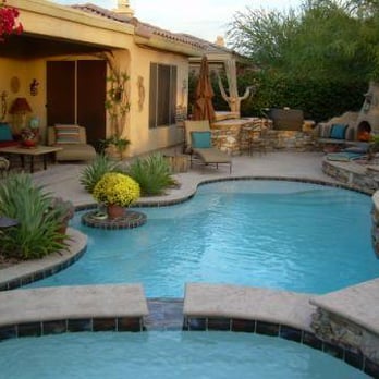 Optima Pools - Custom skimmer/raceway/spillway from the raised spa to the pool with Alcove, dining table and a sun/pet shelf. - Pool & Hot Tub Service Near Me - Phoenix, Arizona Optima Pools - Custom skimmer/raceway/spillway from the raised spa to the pool with Alcove, dining table and a sun/pet shelf. - Pool & Hot Tub Service Near Me - Phoenix, Arizona