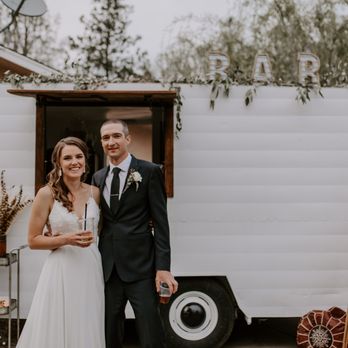Trailer Full - a bride and groom standing in front of a trailer - Coffee & Tea Near Me Trailer Full - a bride and groom standing in front of a trailer - Coffee & Tea Near Me