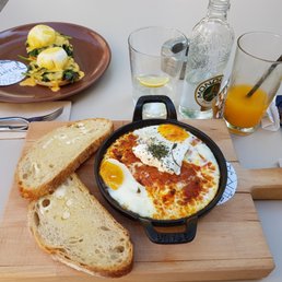 Shakshuka, eggs benedict with spinach and freshly squeezed orange juice Shakshuka, eggs benedict with spinach and freshly squeezed orange juice