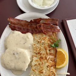 The Breakfast Club - Country breakfast  "The big boy" 12.99$ Gravy biscuits  Choice of meat which I got 4 bacon strips  2poached eggs  Hash browns